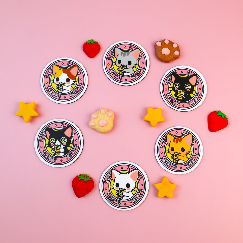 Image of all 6 varieties of the Kitty Treats fridge magnets including the calico cat, grey tabby cat, black cat, ginger tabby cat, white cat, and tuxedo cat versions